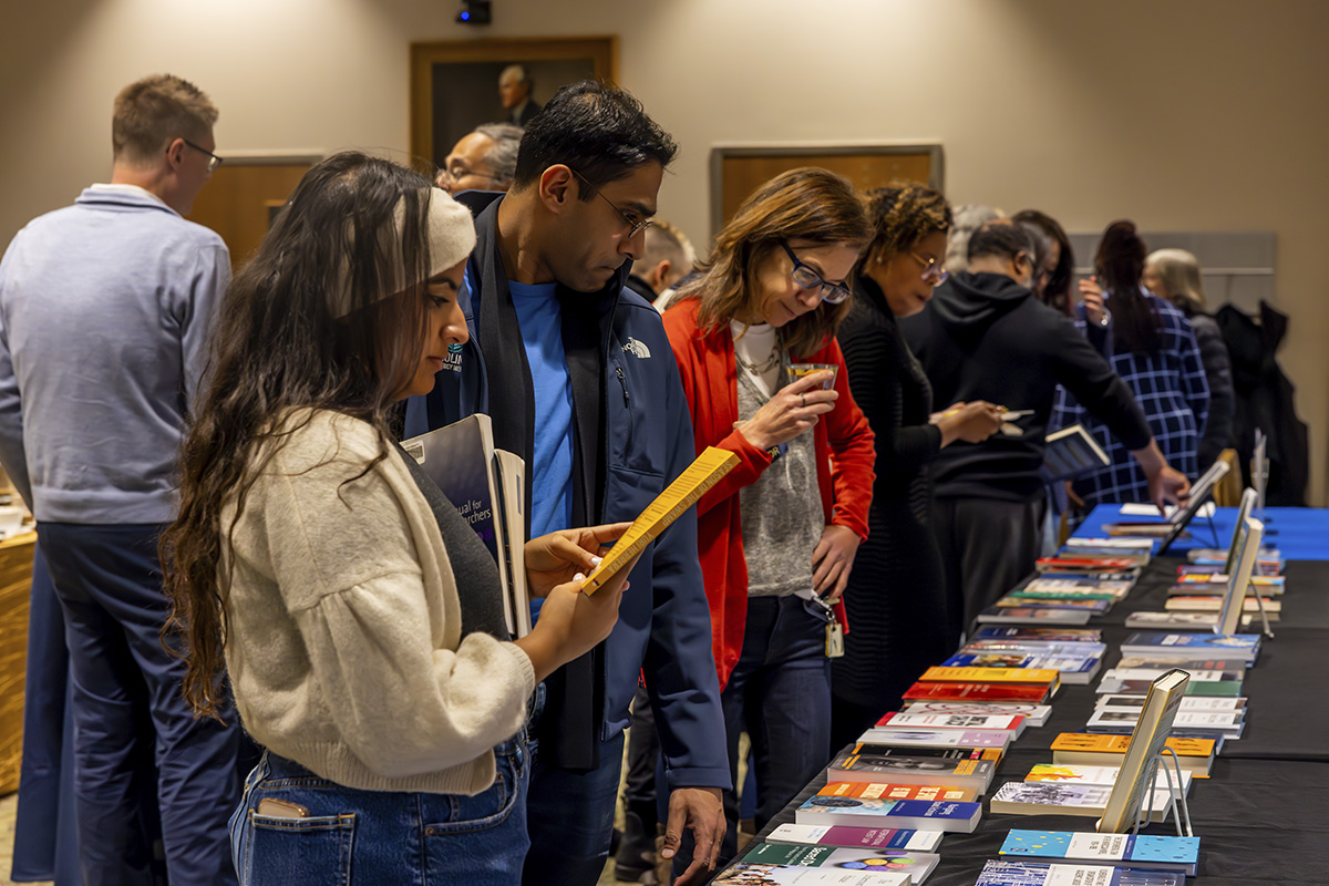 group looking at books on a table