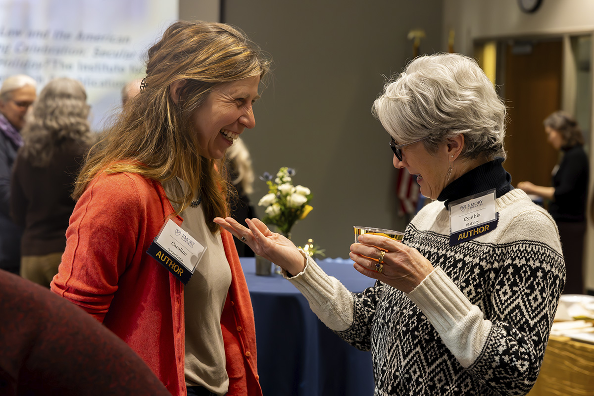 two women laughing and talking