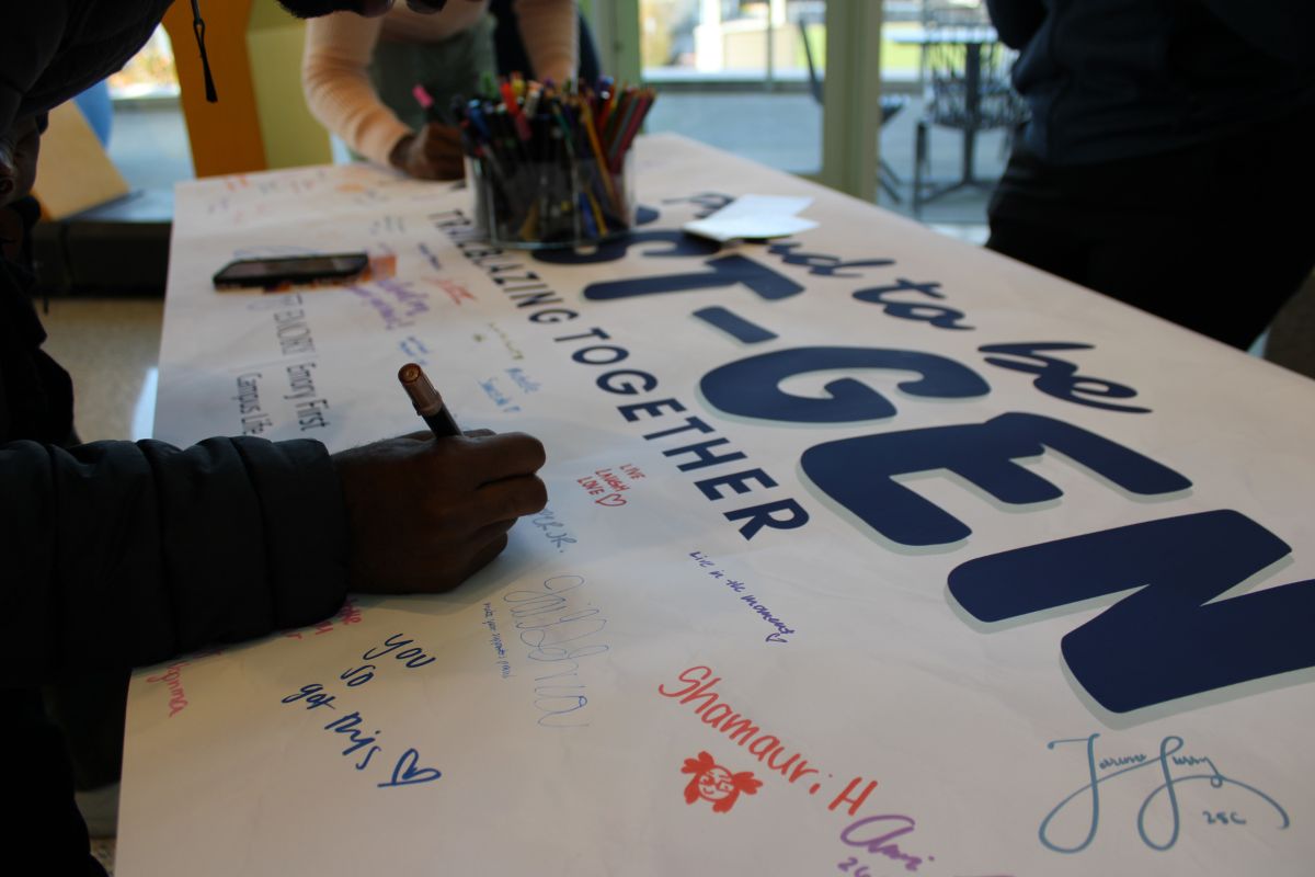 student writing on poster 