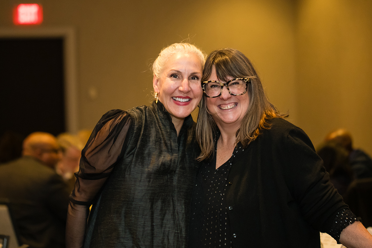 Two women smiling and hugging