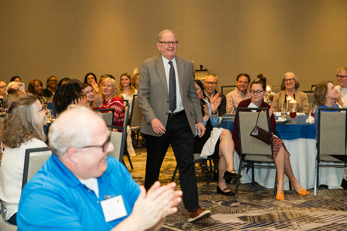 person being honored walks to stage