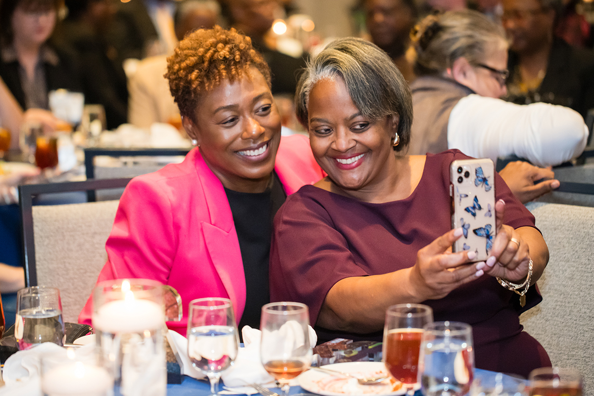 two women taking a selfie and smiling