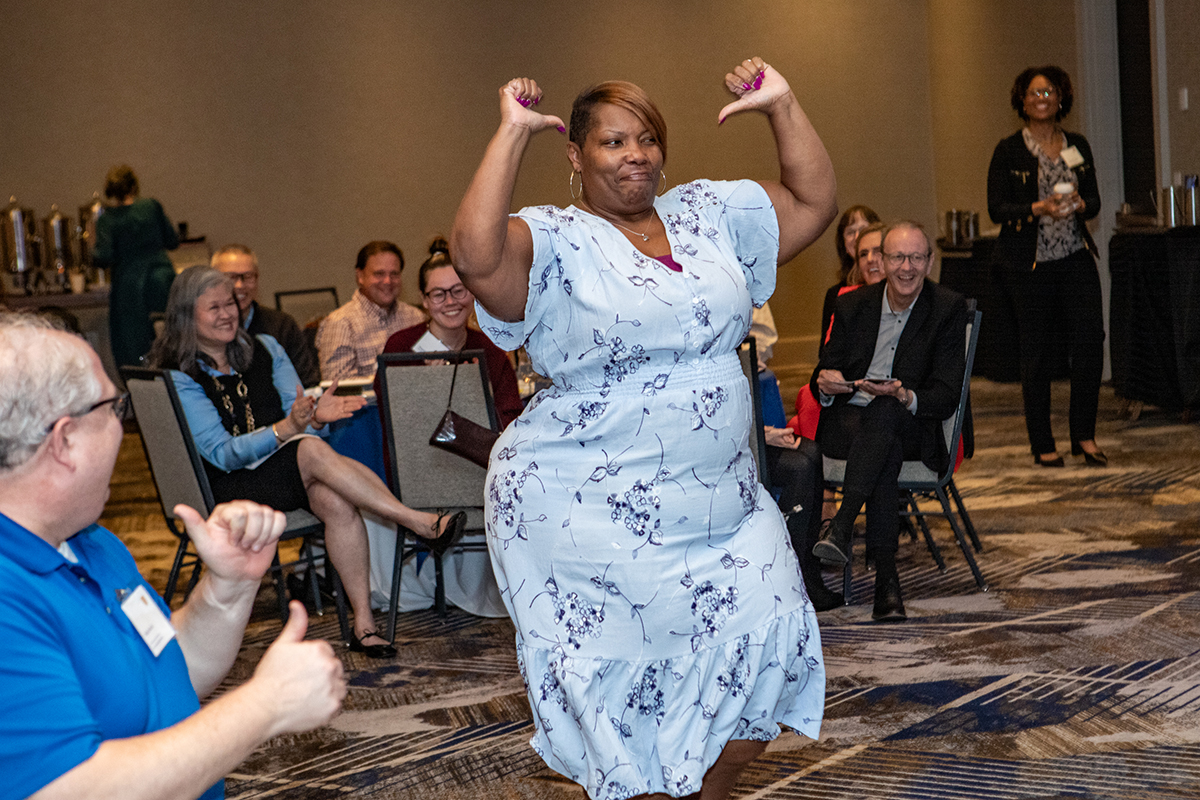 woman being honored dances toward stage