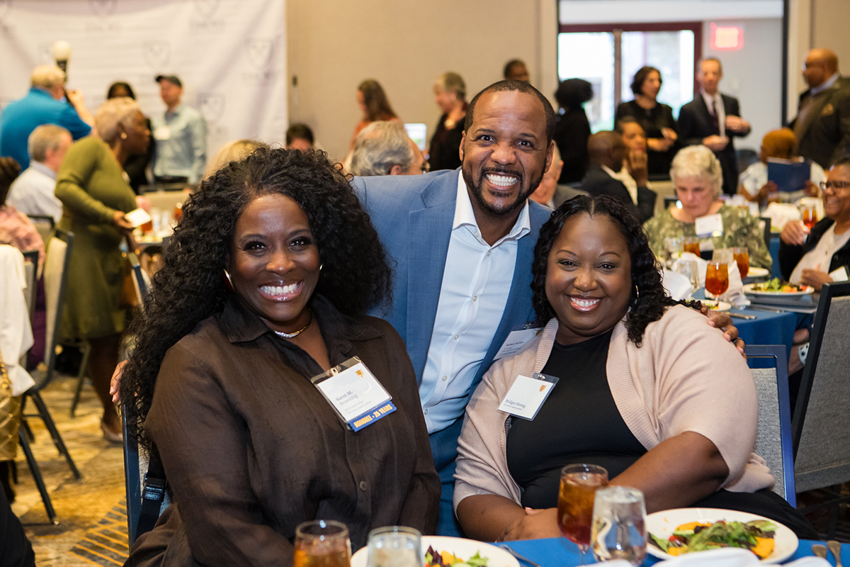 Three colleagues smiling