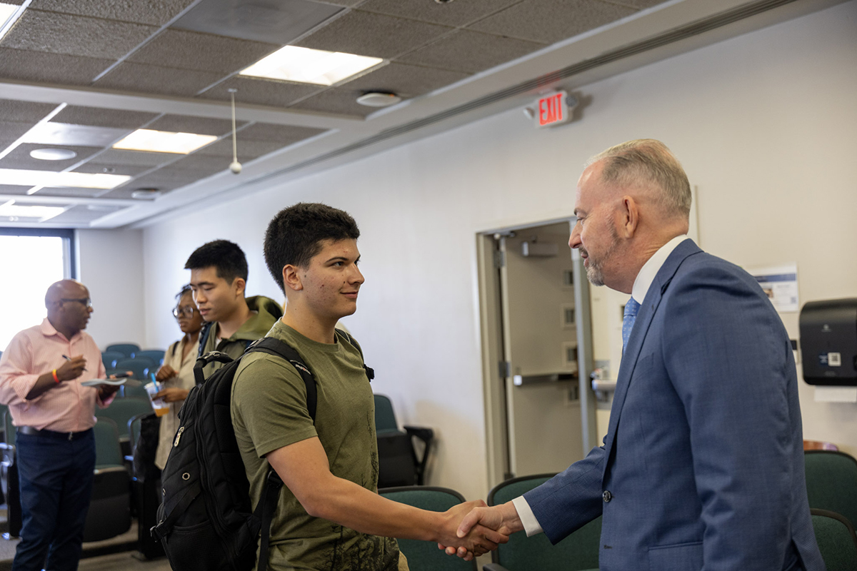 shaking hands with a student