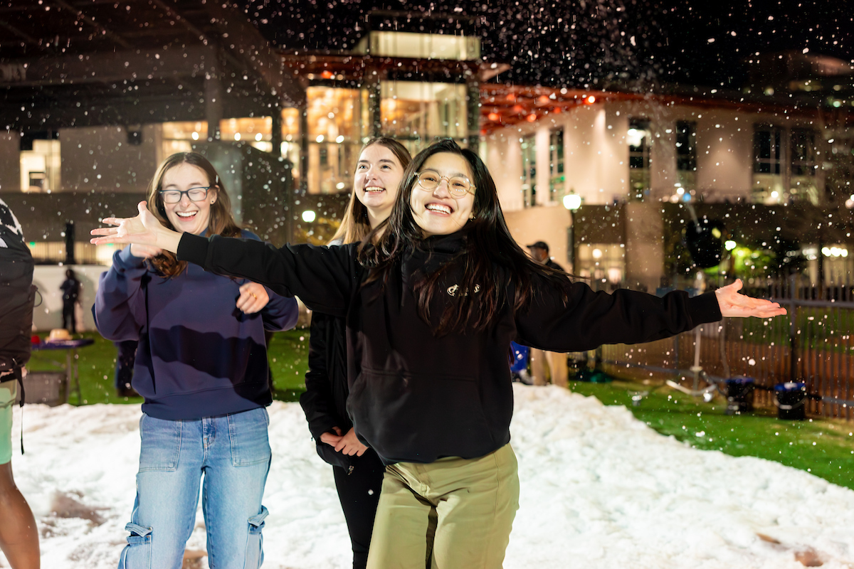 student with arms thrown wide