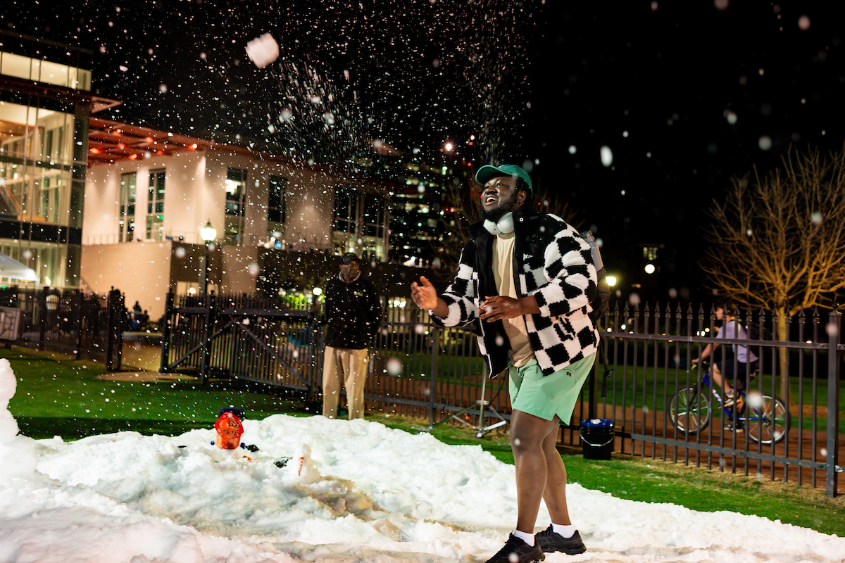 male student throwing a snowball