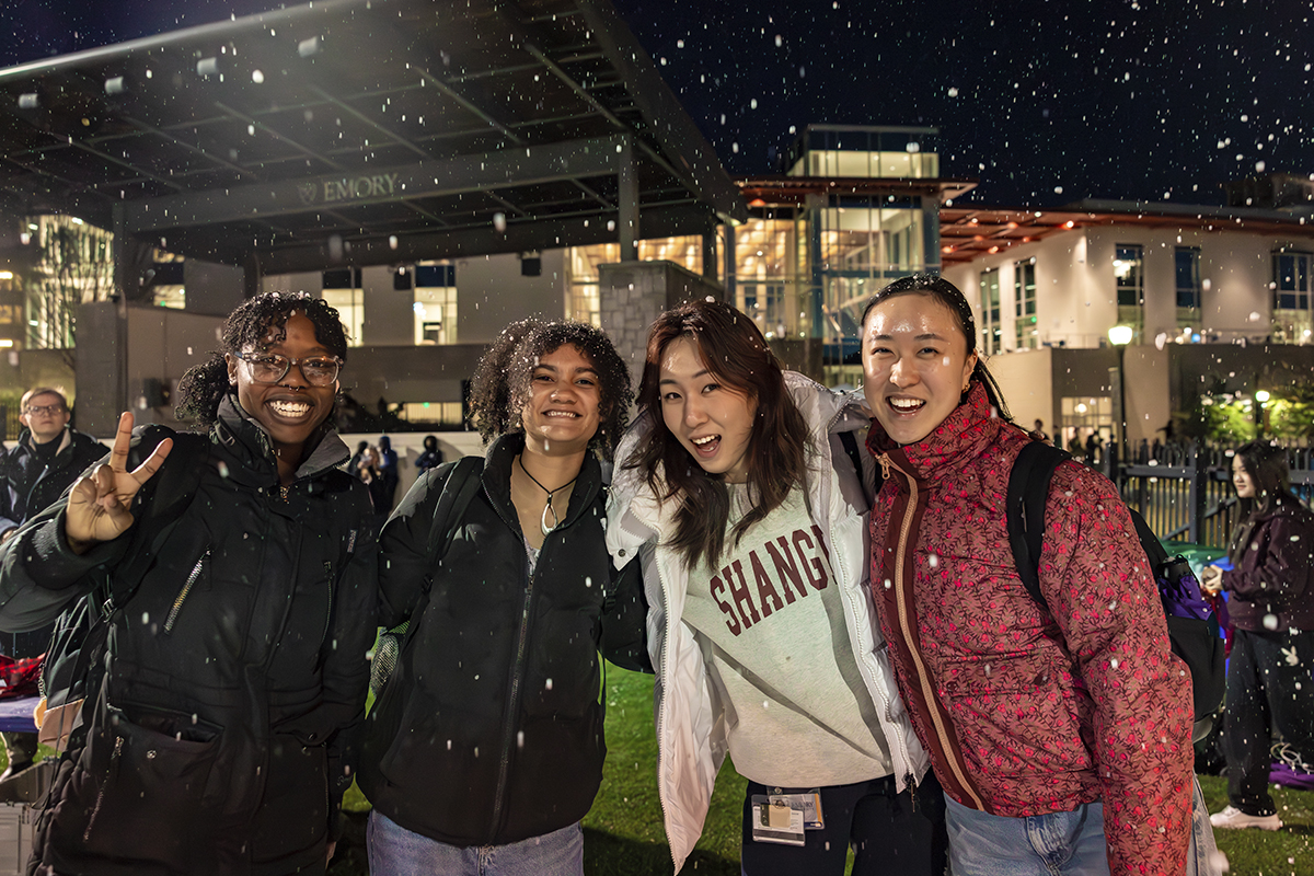 students smiling in snowfall