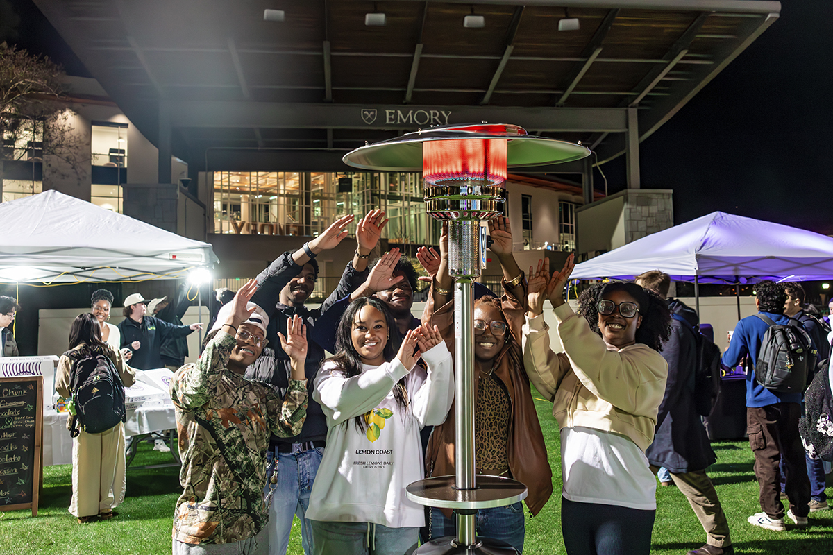 students gathered around heater