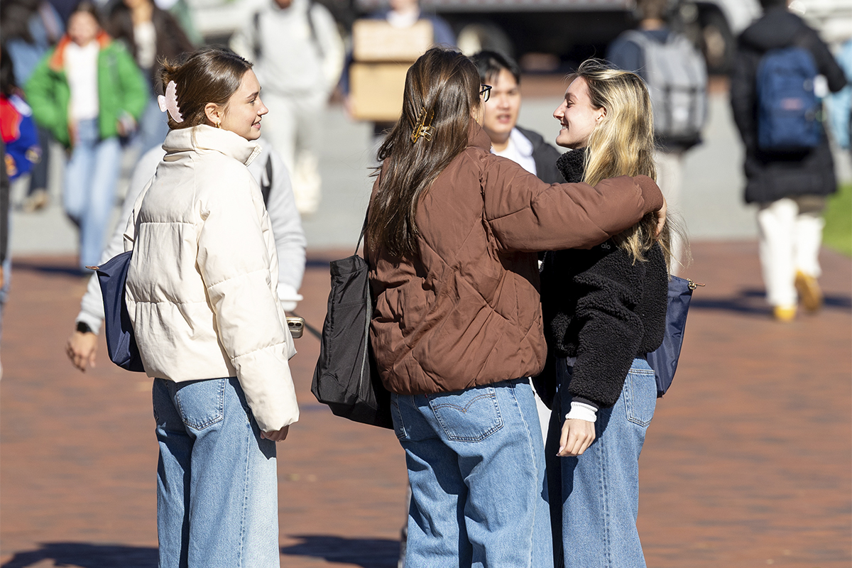 students greeting each other with hug