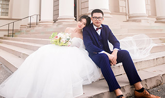 A couple poses in wedding garments