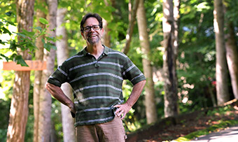 Jerry Grillo poses in a wooded area