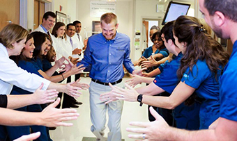 Kent Brantly high-fives the Emory workers who saved his life