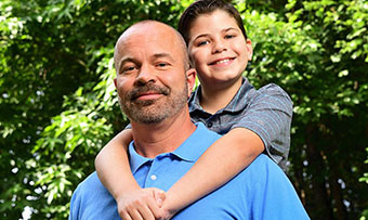 A young boy poses with his dad 