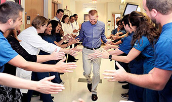 Kent Brantly high fives the team who took care of him when he was discharged at Emory