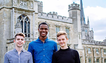 Three Emory students pose in front of a castle in England