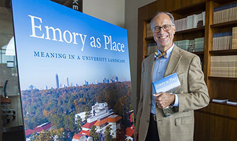 Gary Hauk stands in front of a display of his new book "Emory as Place"