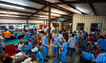 Migrant farm workers get health screenings in a large building