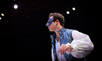 A student in a mask performs on stage