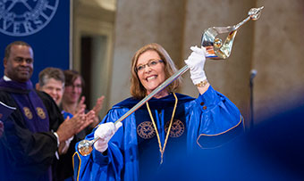 President Claire E. Sterk holds the university mace