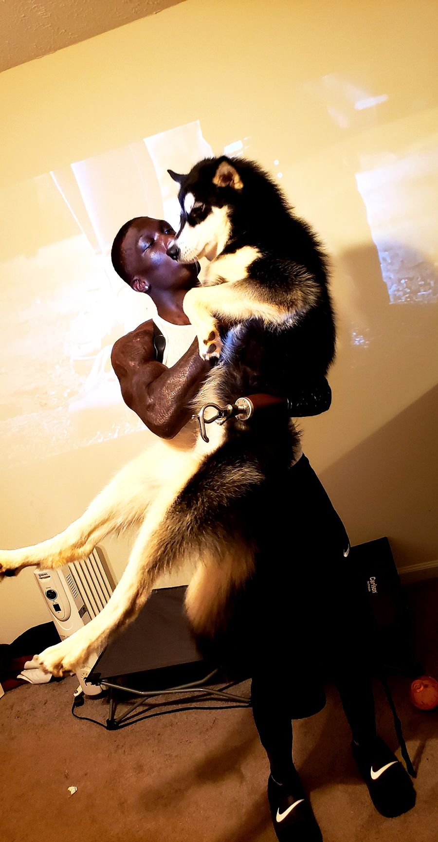 Jalen Richardson holds Shadow, an Alaskan malamute, who became his new training partner.