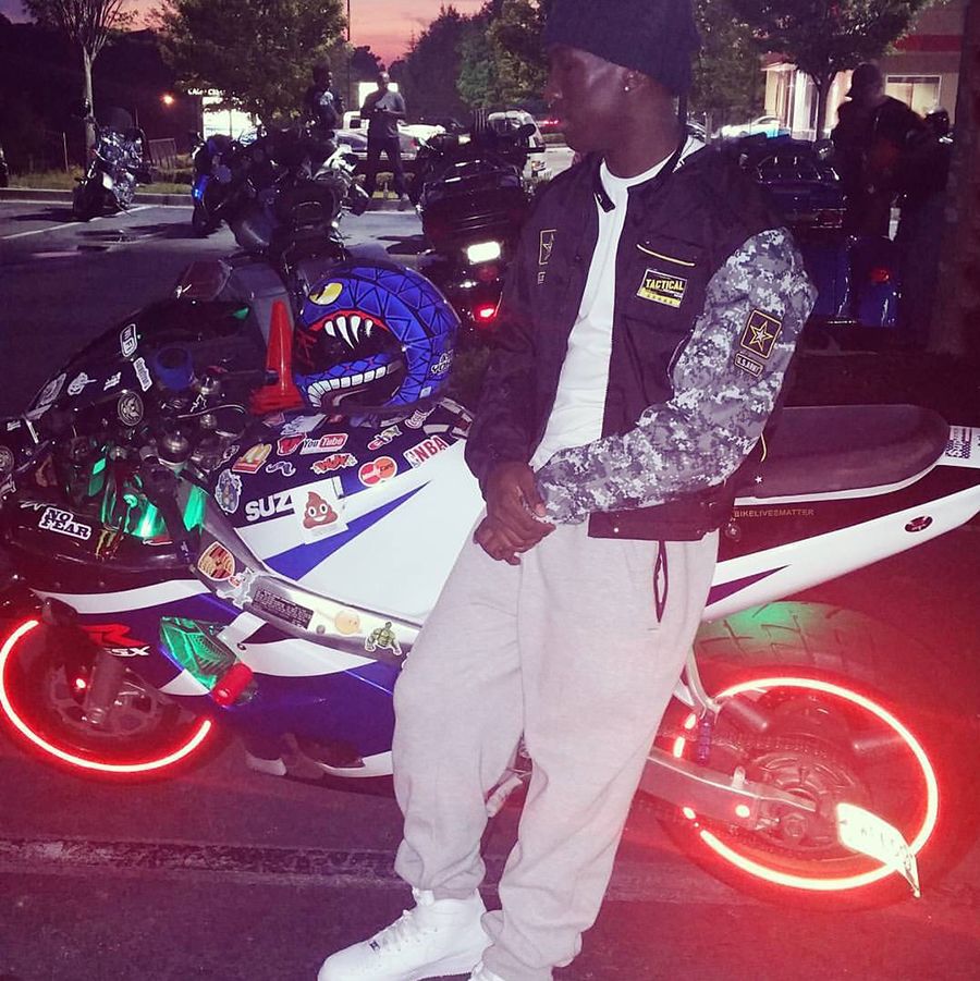 Jalen Richardson leans against his flashy blue-and-white Suzuki GSX — a sleek, agile machine noted for its power.