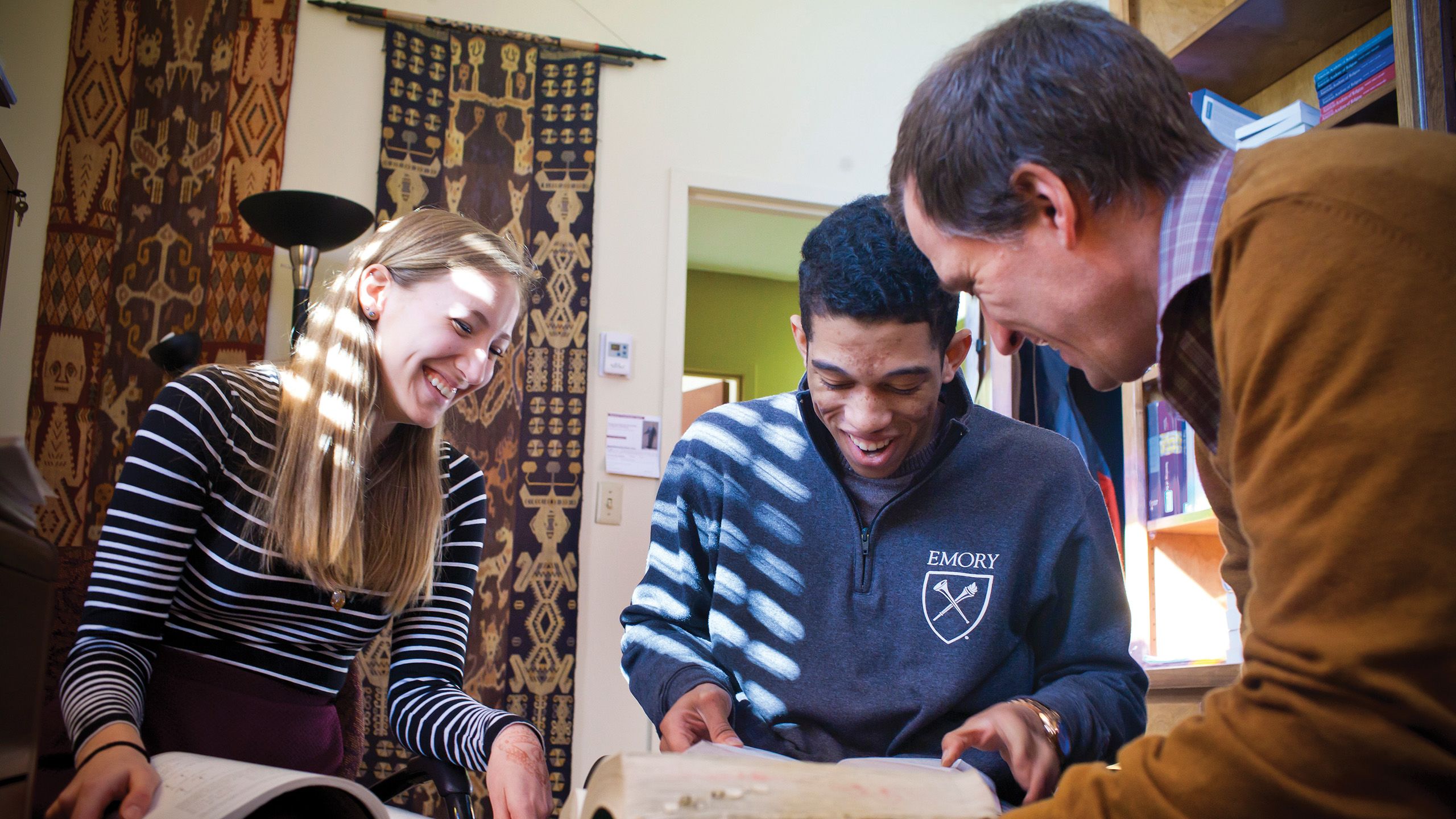 Emory students with professor in his office