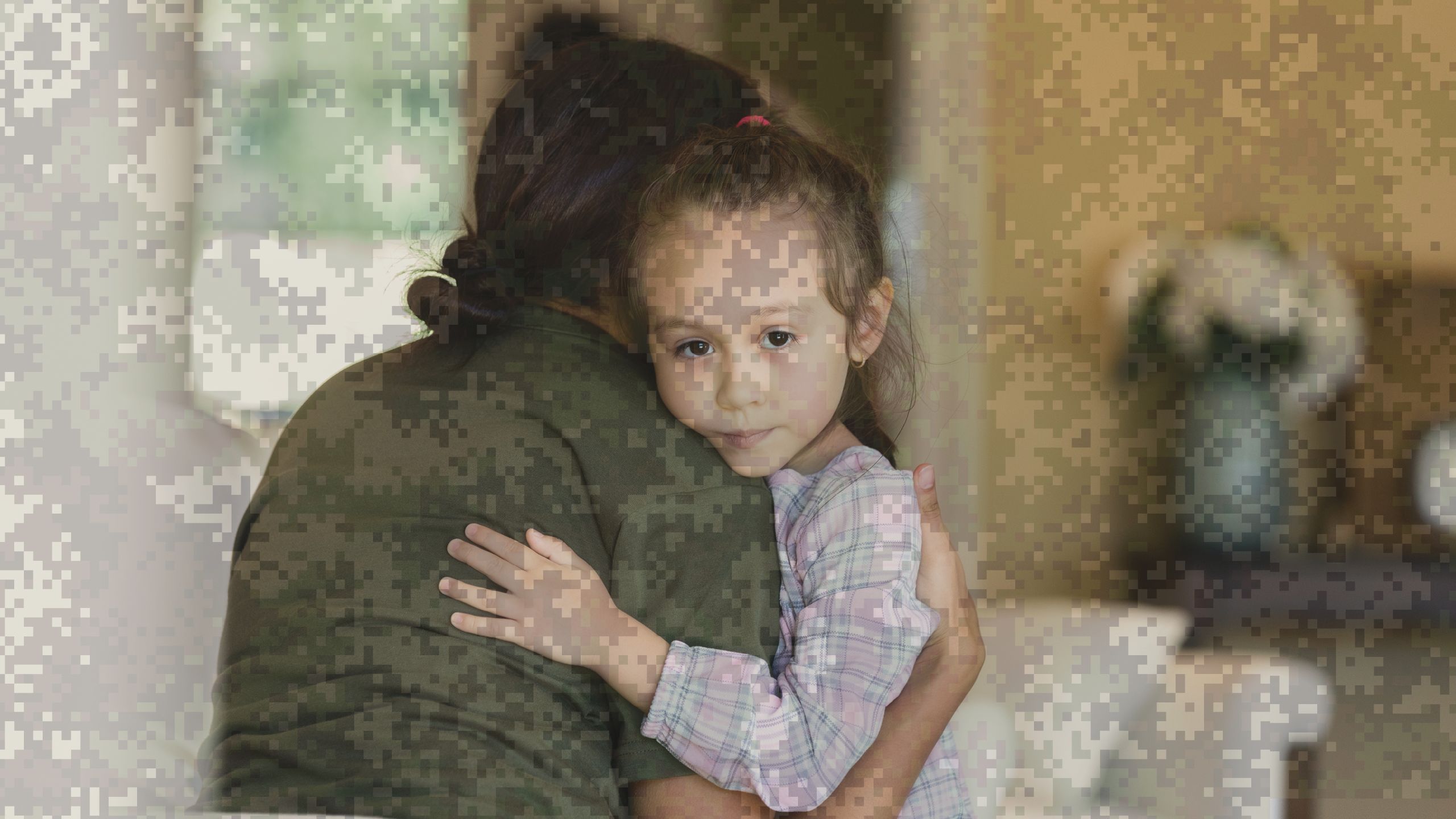 A woman hugging her young daughter