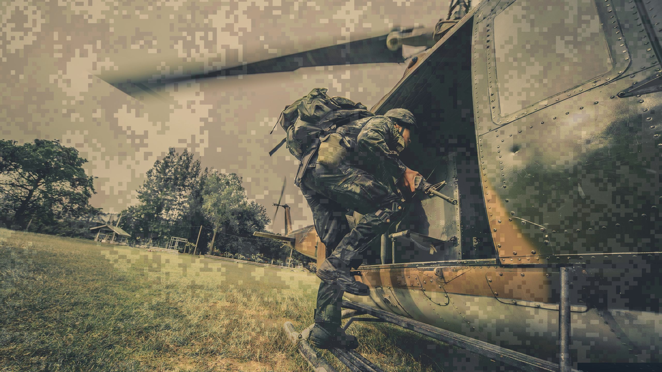 A soldier gets out of a helicopter