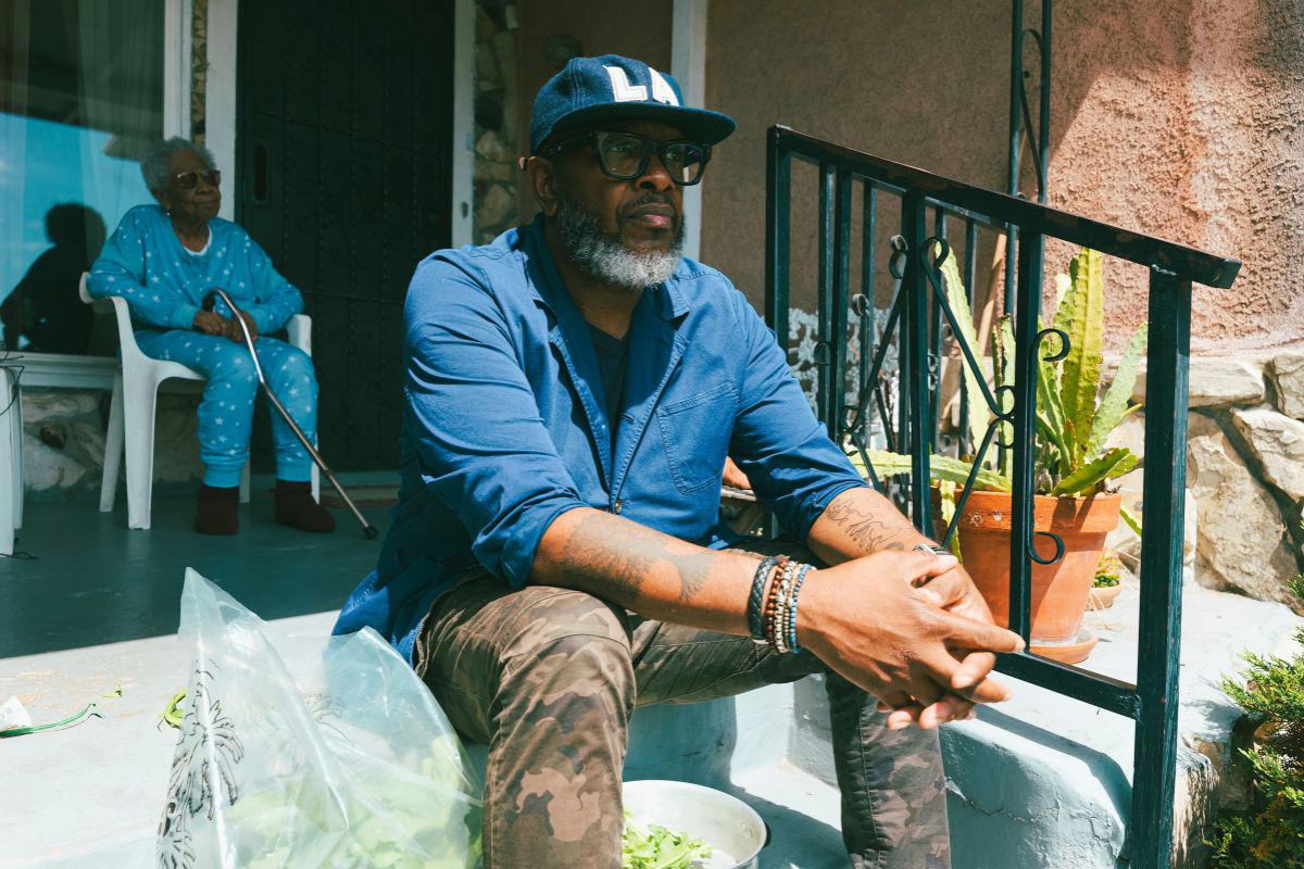 Derek Hicks sitting on a front porch