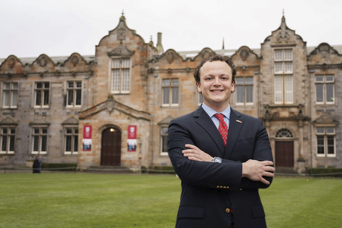 emory university alumnus Lucas San Miguel standing in front of St Andrews College in Scotland